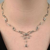 A brilliant-cut diamond star motif necklace.