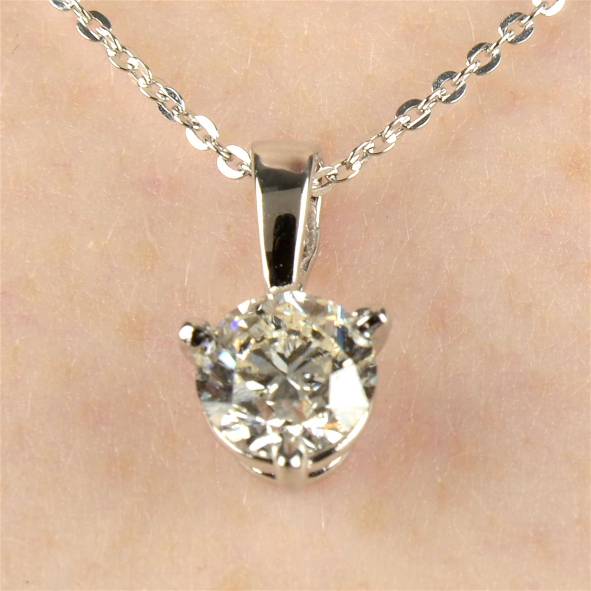 An 18ct gold brilliant-cut diamond single-stone pendant, with platinum chain.