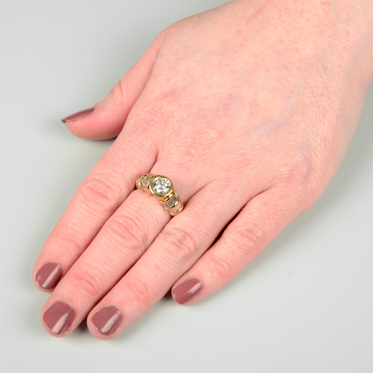 A brilliant-cut diamond dress ring, with baguette-cut diamond shoulders. - Image 5 of 6