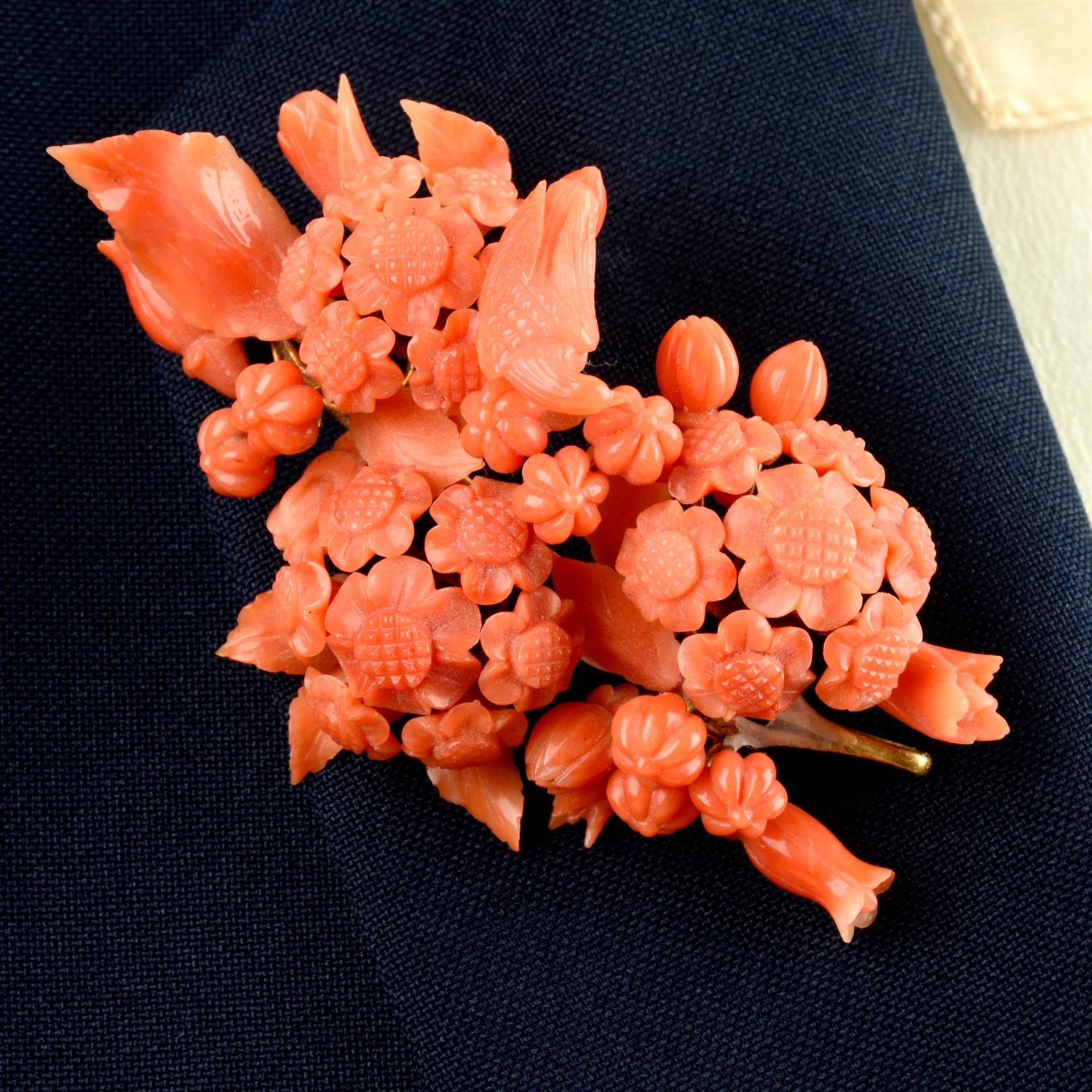 An early to mid 19th century gold mounted carved coral demi parure, consisting of bracelet,