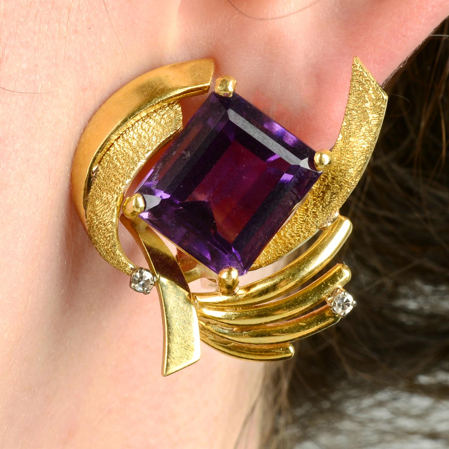 A pair of amethyst and diamond textured earrings.