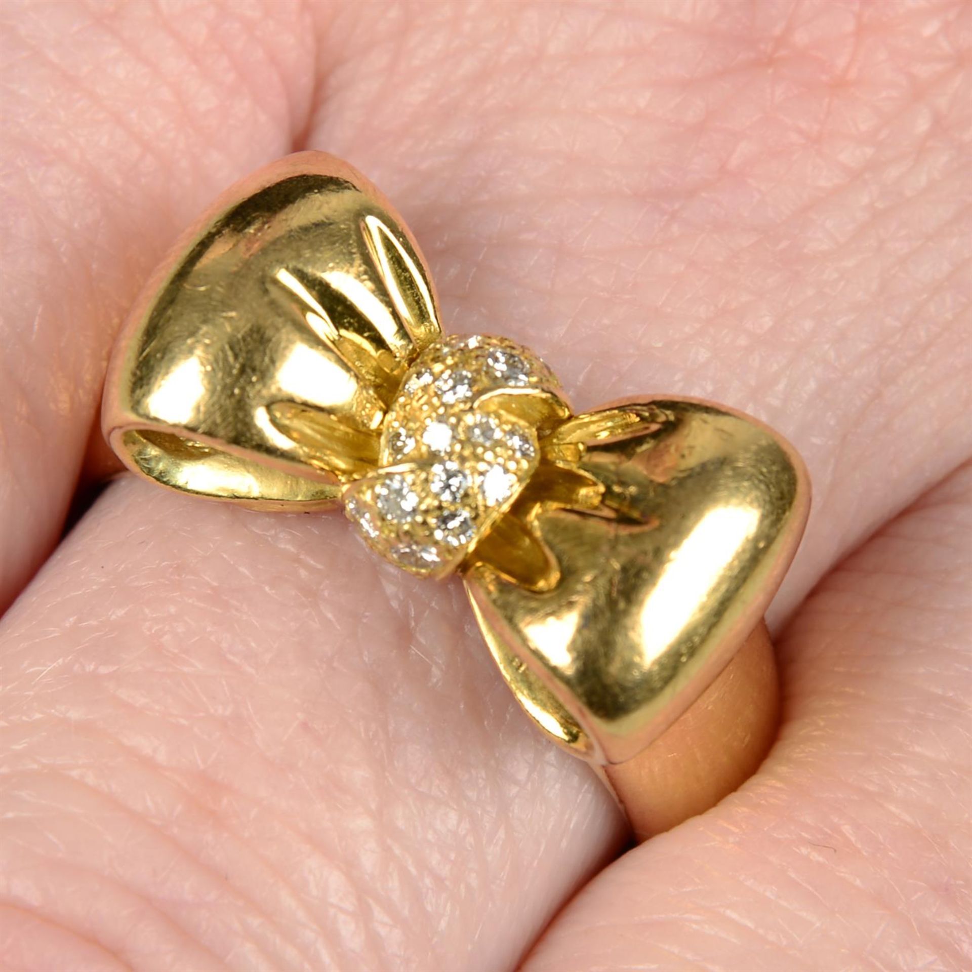 A pavé-set diamond bow ring, by Van Cleef & Arpels.