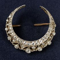 A late Victorian silver and gold rose and old-cut diamond openwork crescent moon brooch.