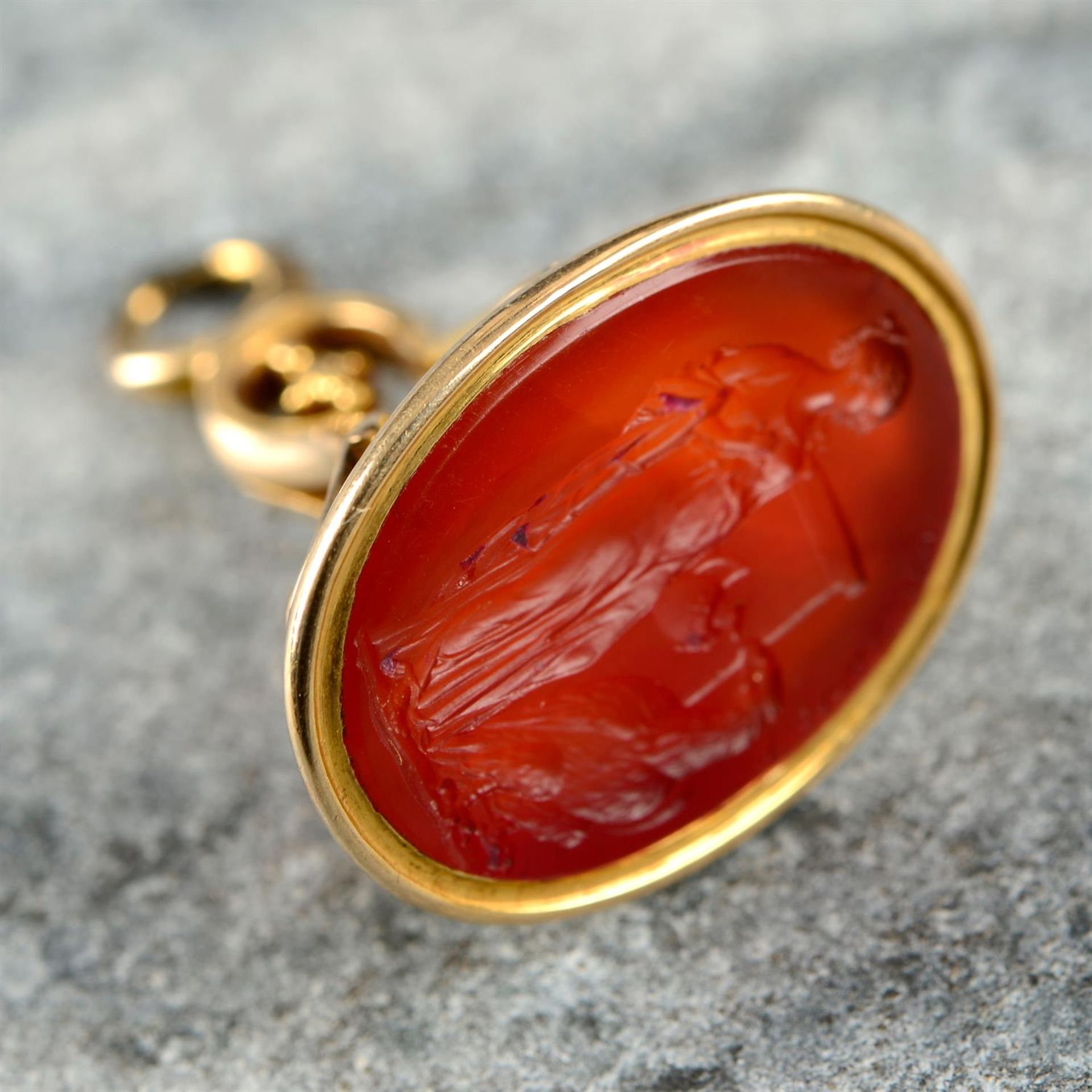 A late Georgian gold carnelian intaglio of Hebe feeding Zeus as an eagle, by William Brown.