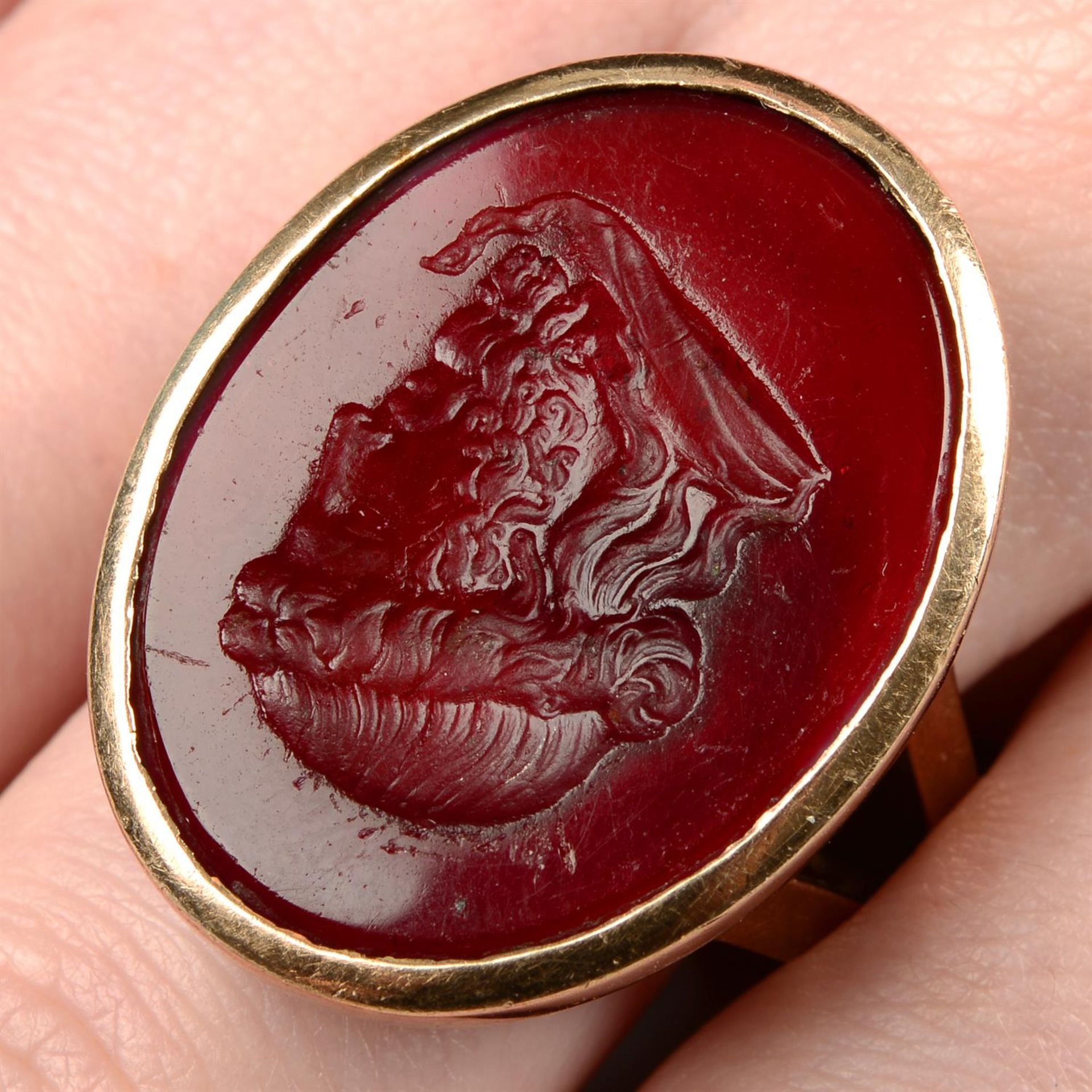 A late 19th century 9ct gold glass intaglio ring, believed to depict Zeus.