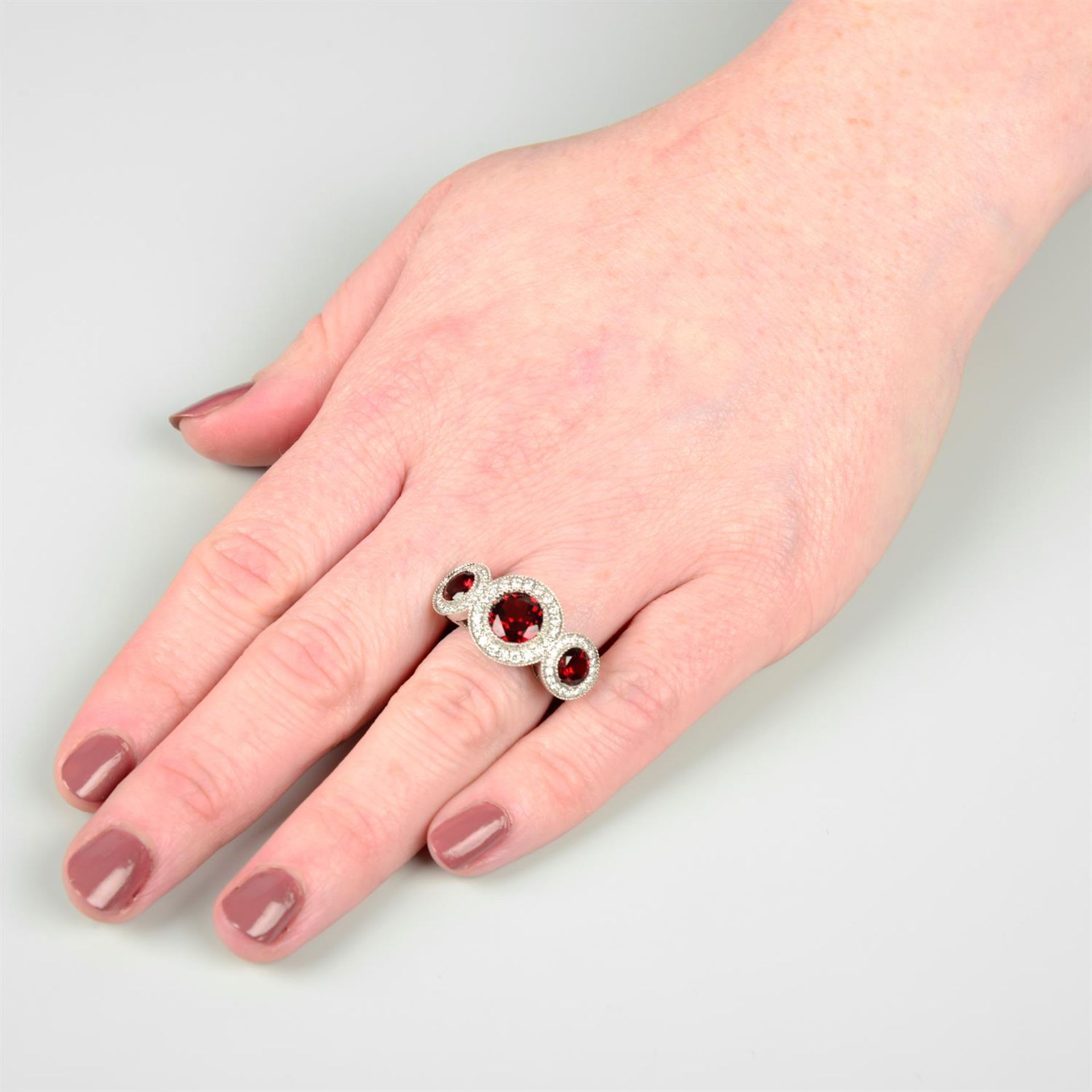 An 18ct gold garnet and brilliant-cut diamond triple cluster ring. - Image 5 of 5