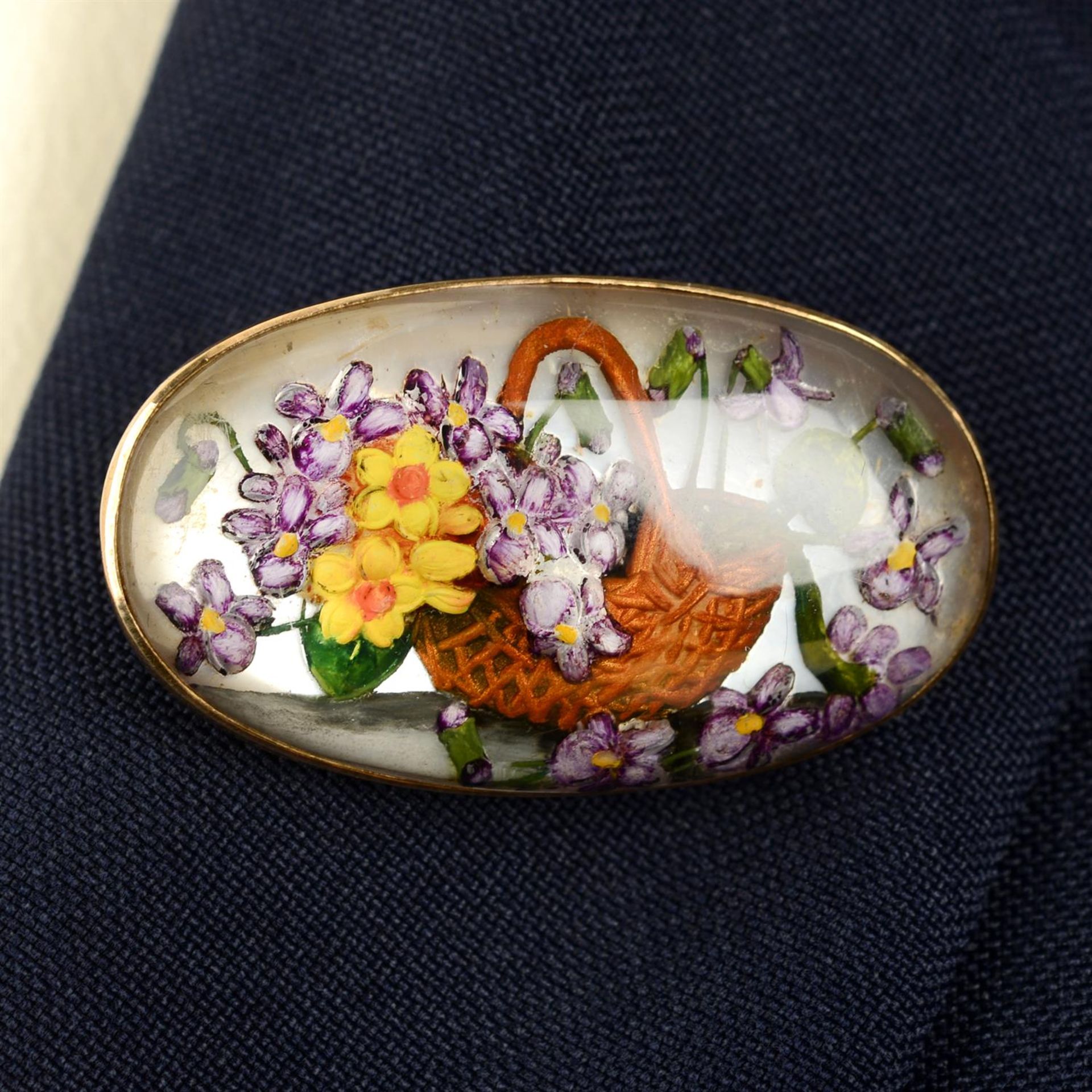 A late 19th century gold reverse carved and painted rock crystal floral brooch.