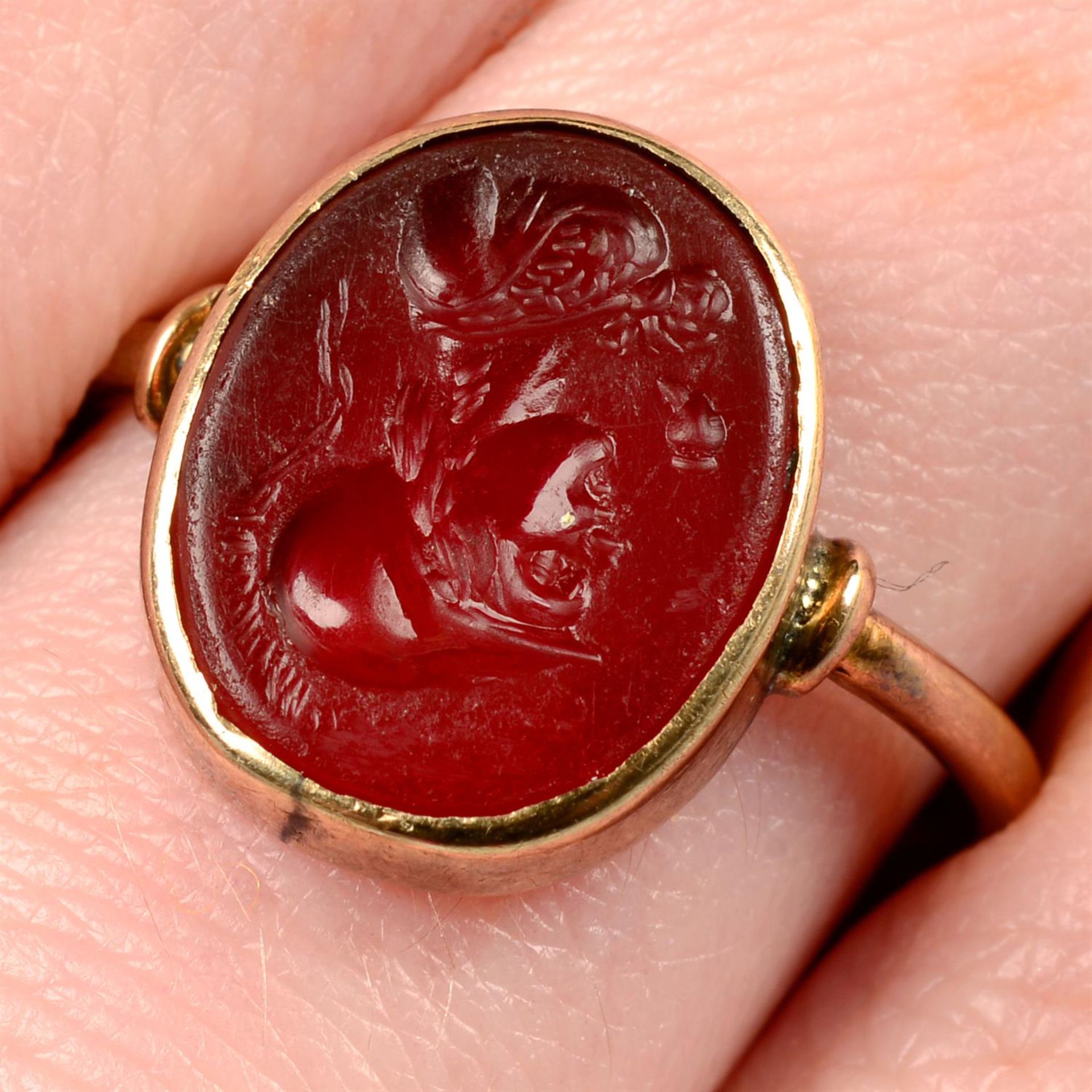 A 19th century gold carnelian intaglio ring, carved to depict Athena with owl attribute.