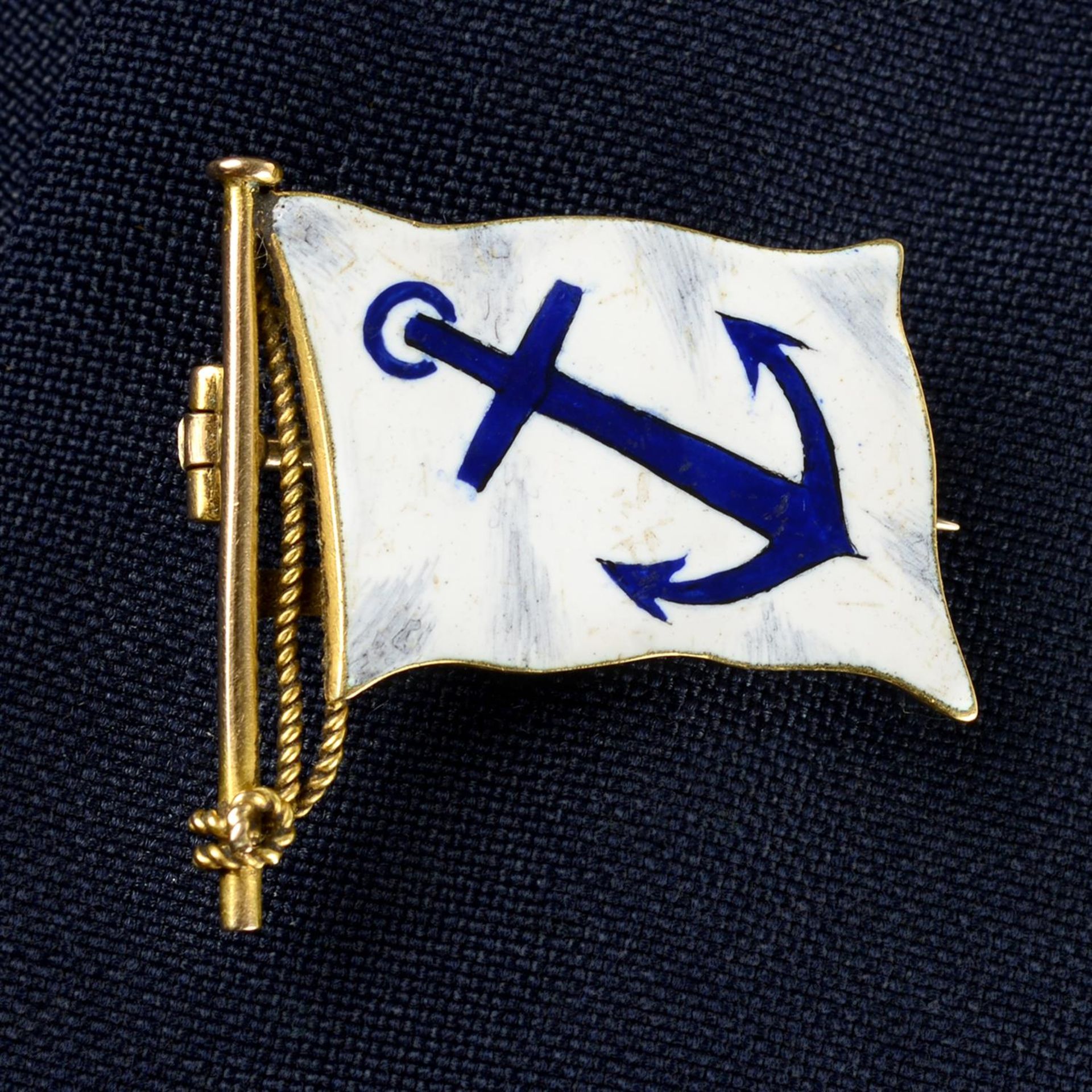 An early 20th century 15ct gold enamel anchor flag brooch.