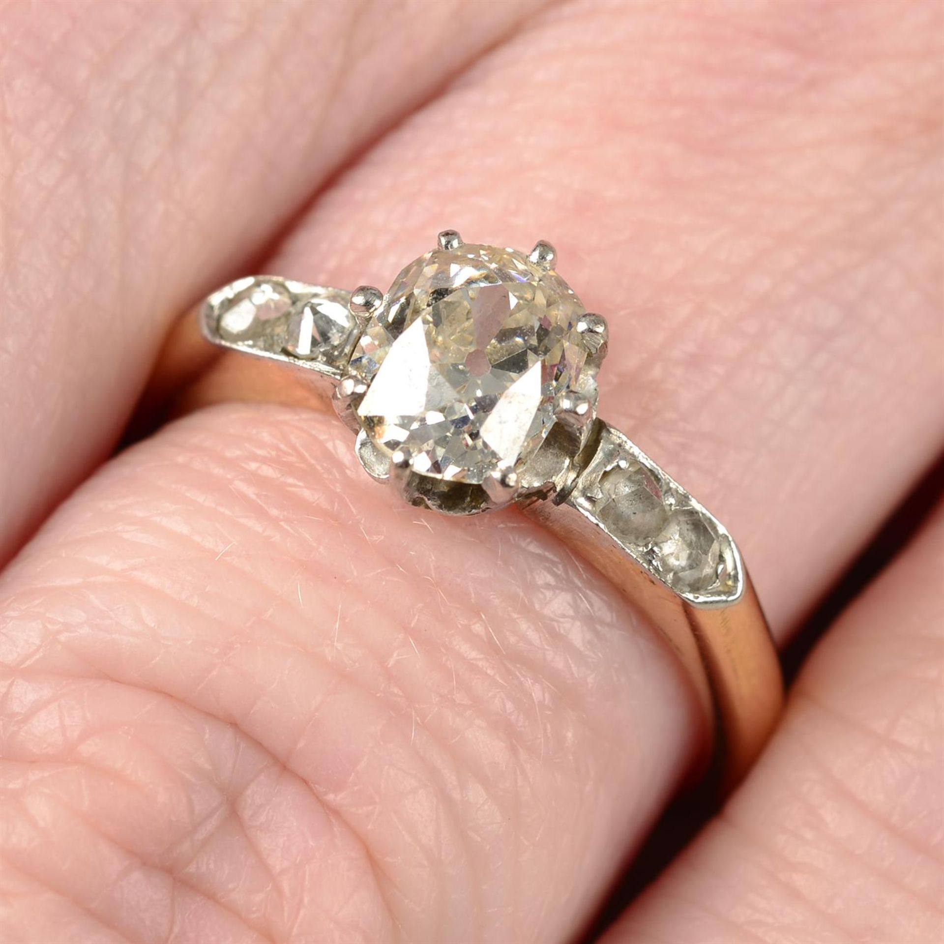 An early 20th century 18ct gold old-cut diamond single-stone ring, with vari-cut diamond shoulders.