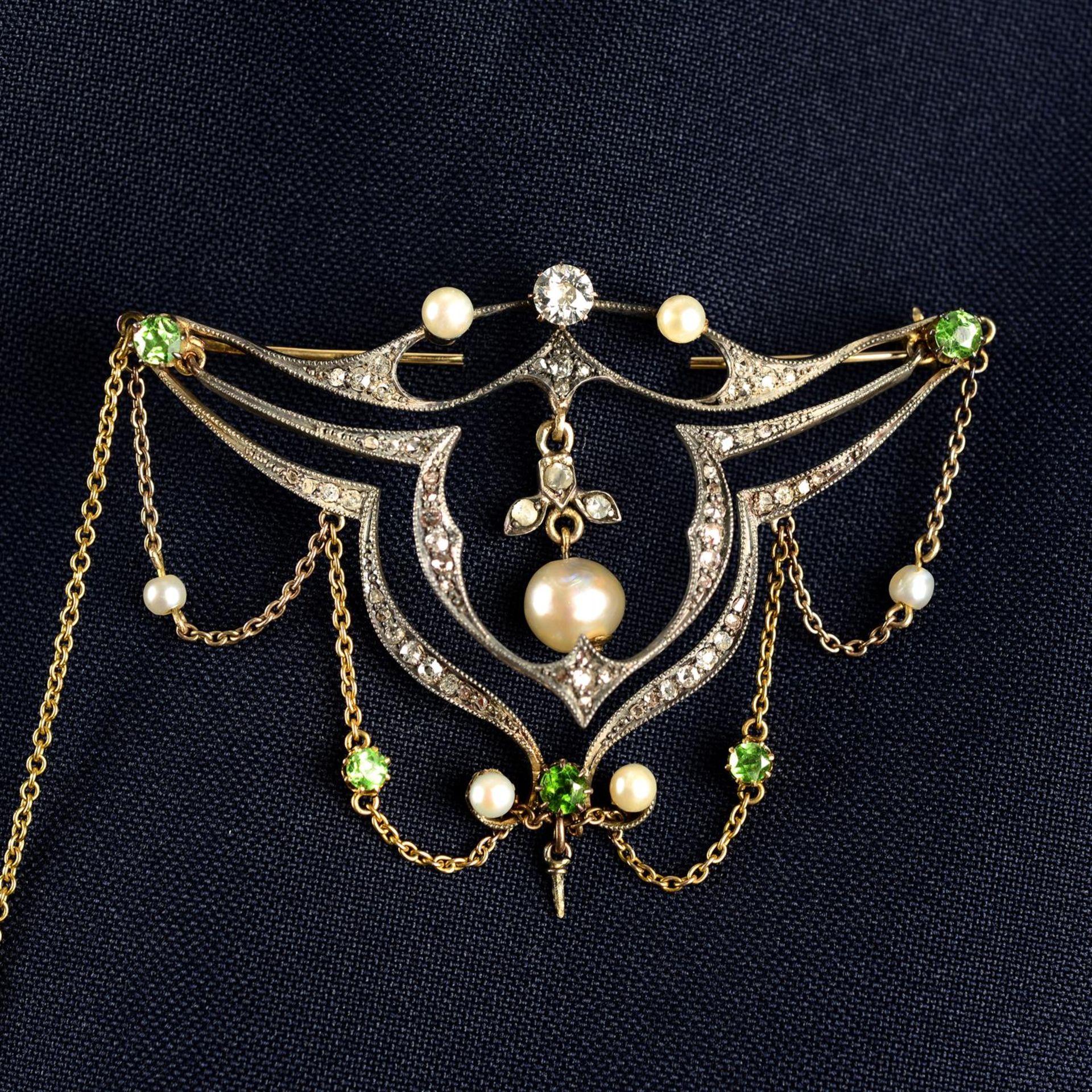 A late 19th century silver and gold, vari-cut diamond, demantoid garnet and pearl brooch.