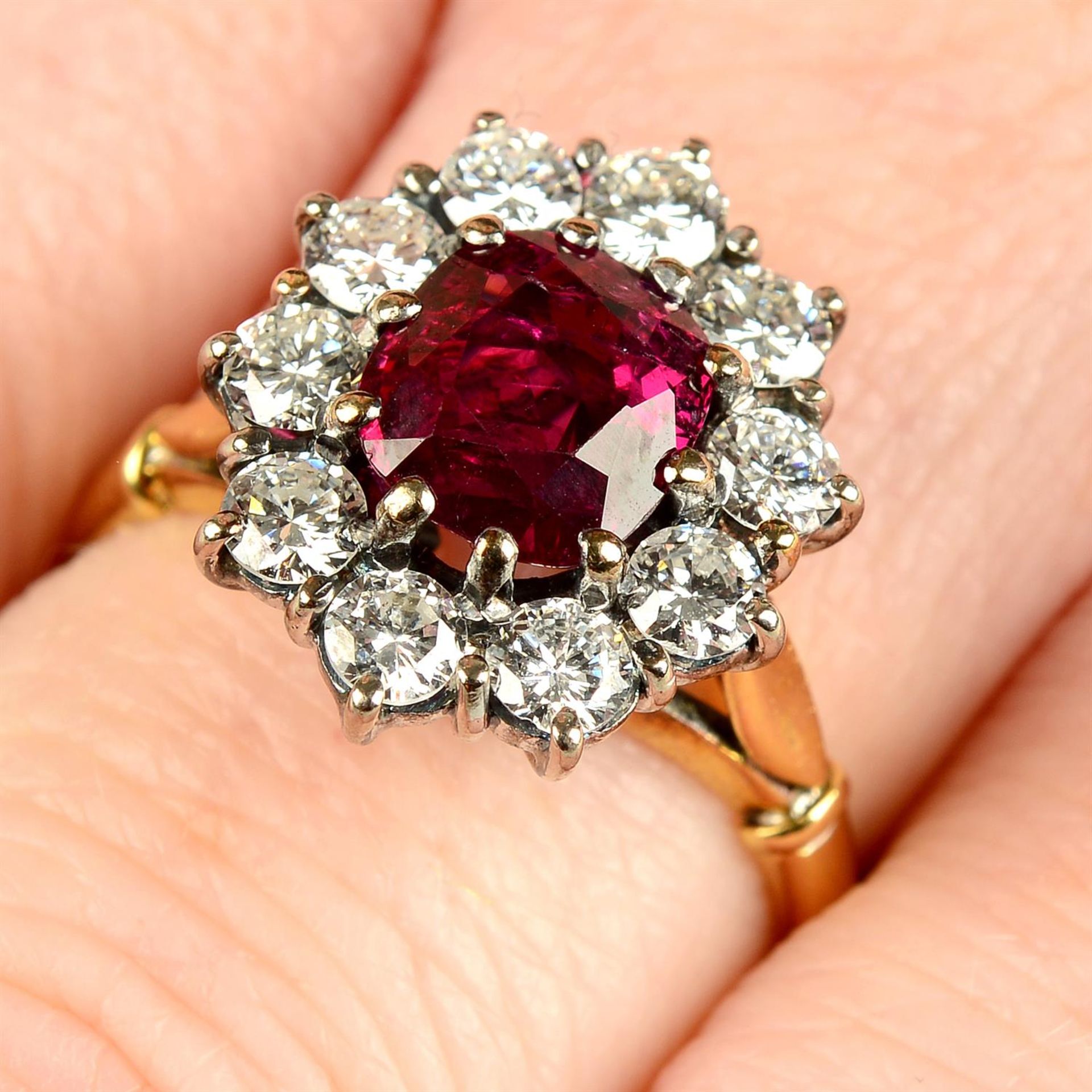 An 18ct gold ruby and brilliant-cut diamond cluster ring.