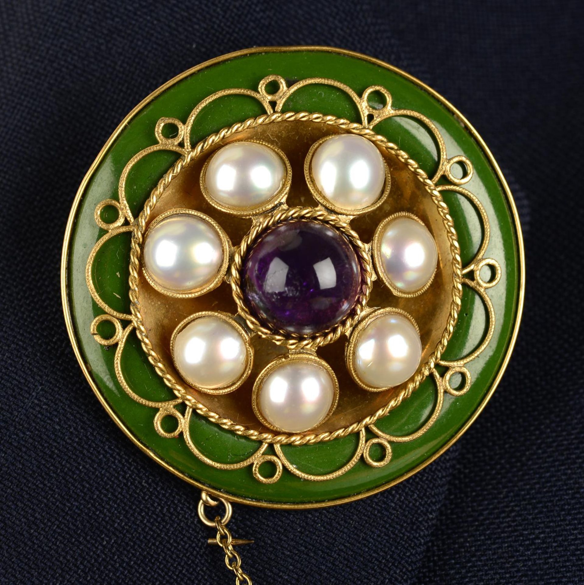 An early 20th century gold, amethyst, split pearl and green glass brooch, with Suffragette colours.