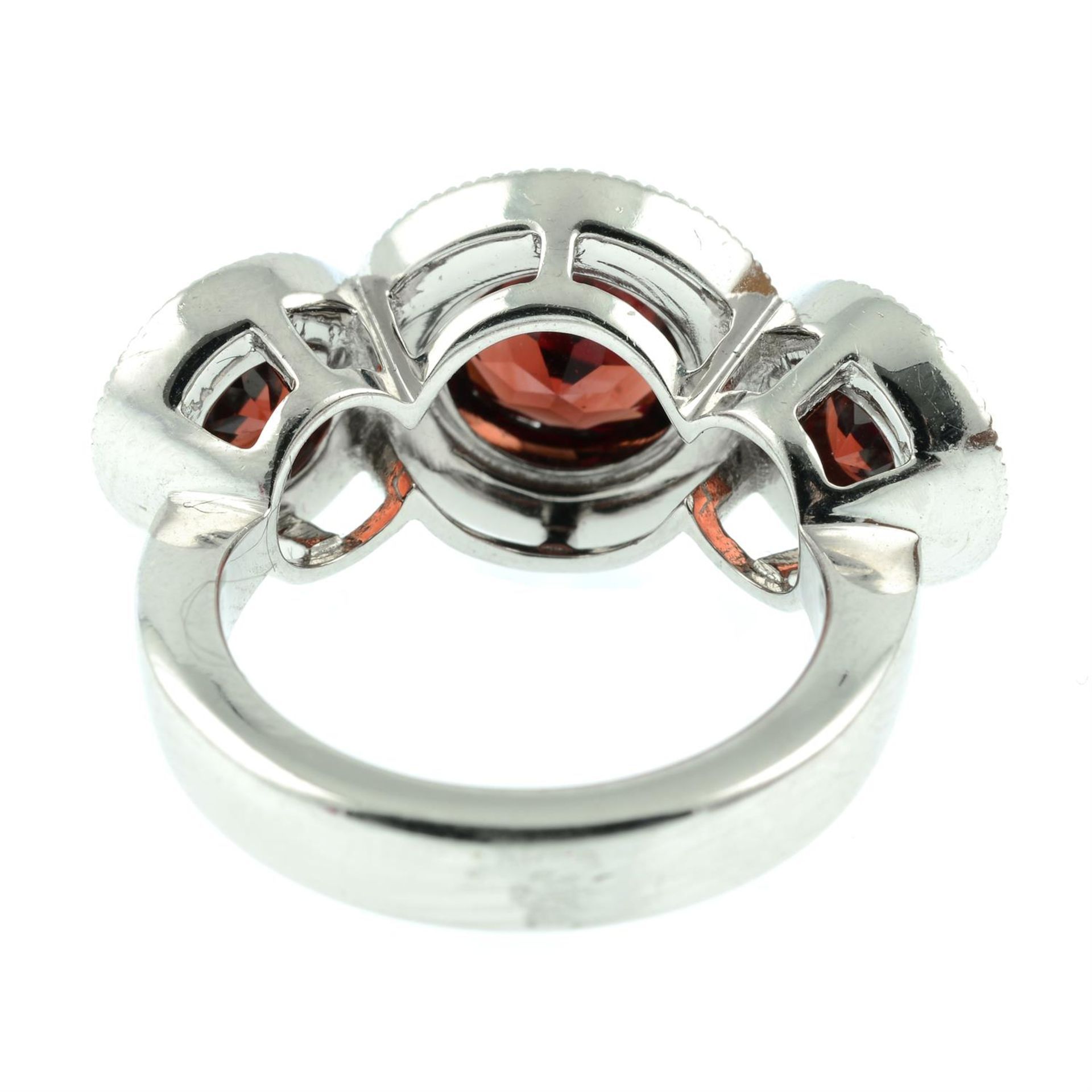 An 18ct gold garnet and brilliant-cut diamond triple cluster ring. - Image 4 of 5