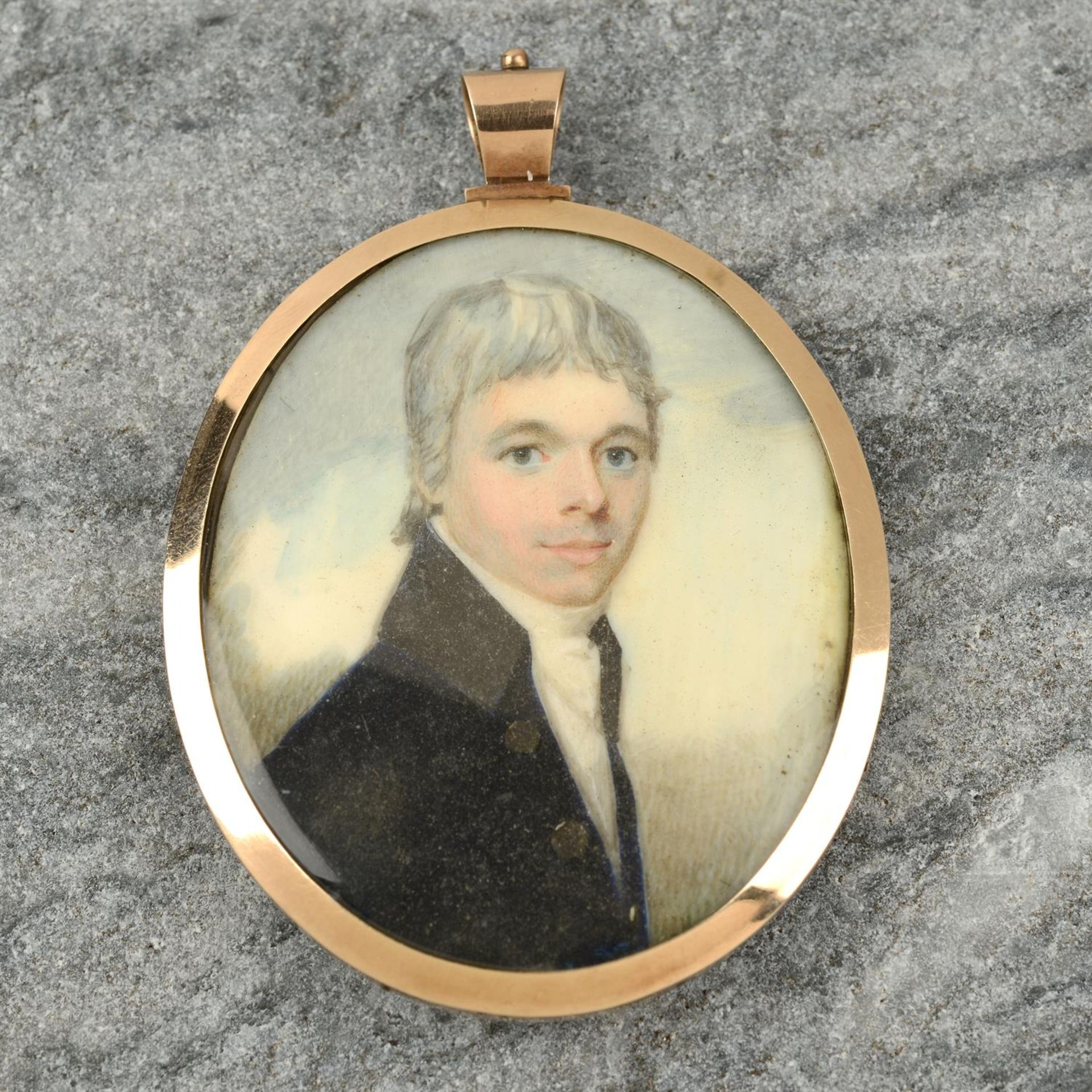 A 19th century gold mounted portrait miniature of a gentleman, with hairwork reverse.