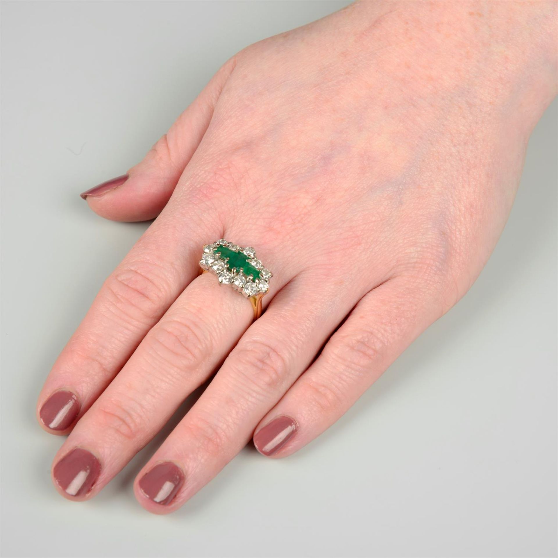 An 18ct gold emerald three-stone and brilliant-cut diamond cluster ring. - Image 5 of 5