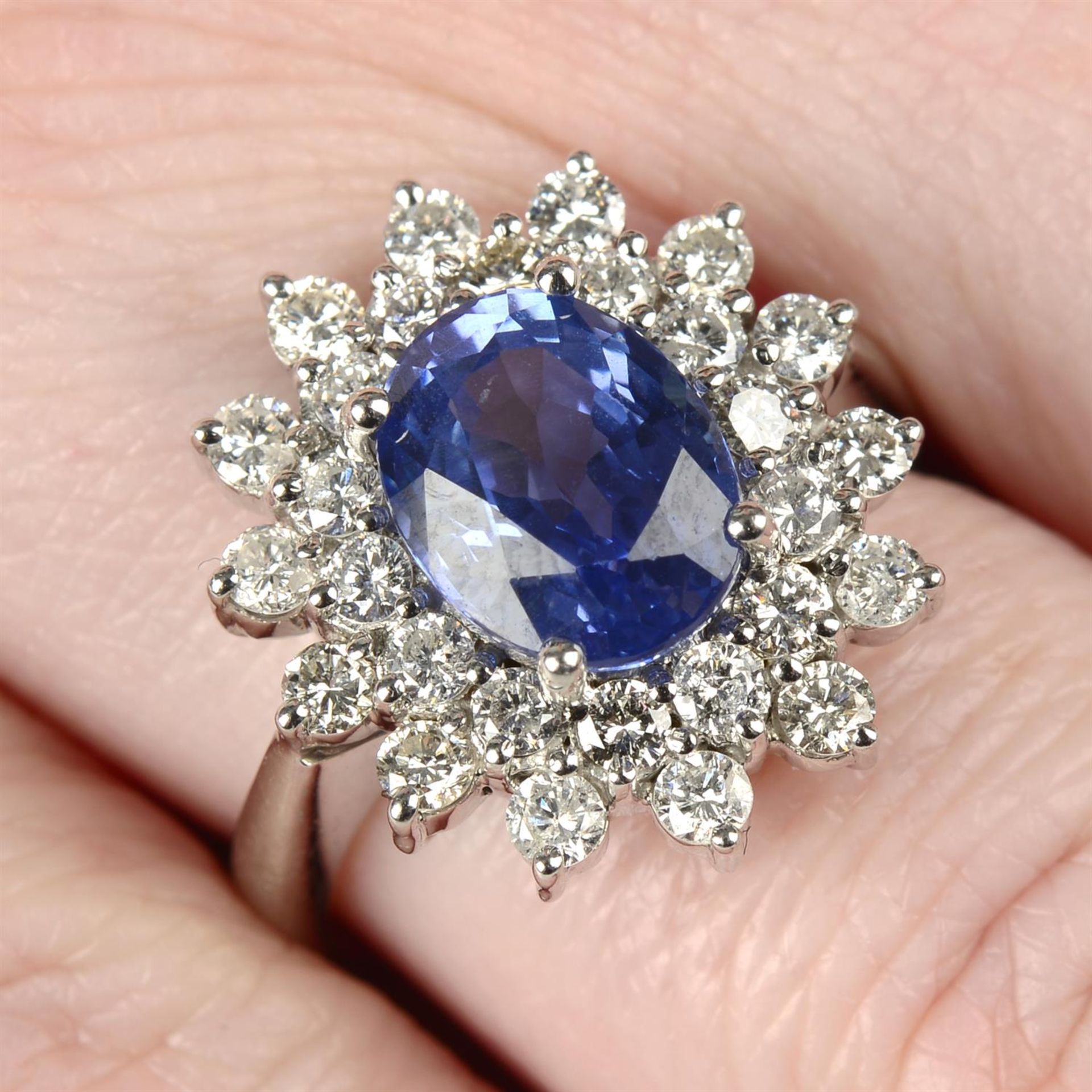 An 18ct gold brilliant-cut diamond and sapphire cluster ring.