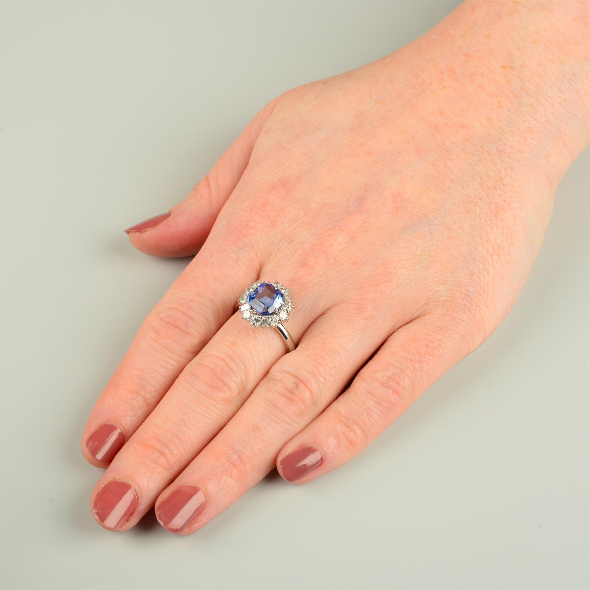 A Madagascan sapphire ring, with brilliant and baguette-cut diamond surround. - Image 5 of 5