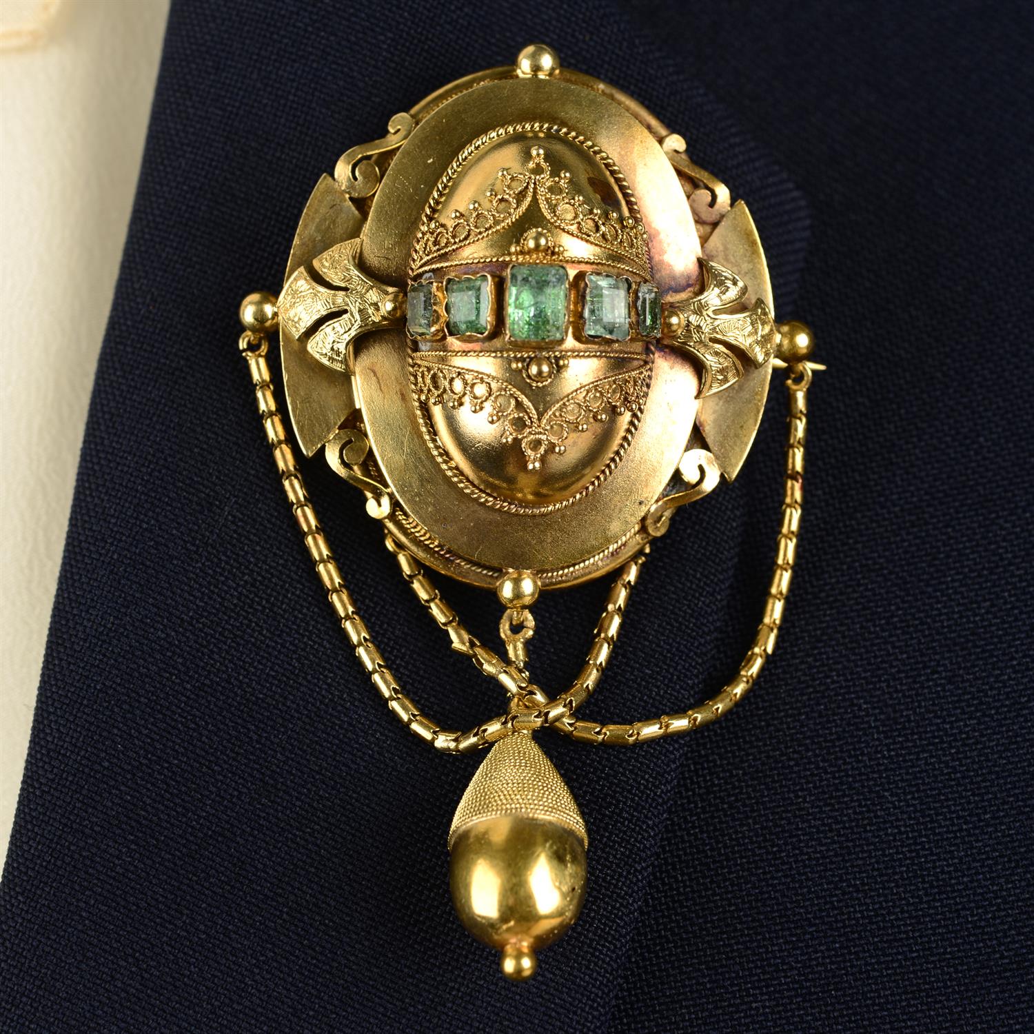 A mid 19th century gold foil-back green gem cannetille locket brooch, with matching earrings.