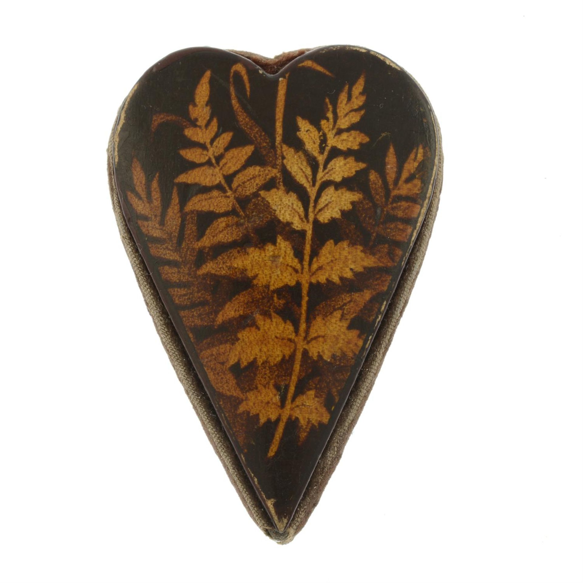 A late 19th century heart-shape fern motif pin cushion, with five pins.