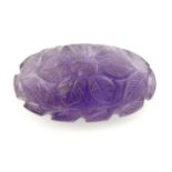 An oval carved amethyst, carved to depict floral motif, weight 62.94cts.