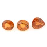 Three cushion and pear-shape orange garnets, weight 4.05cts, 2.95cts and 2.90cts.