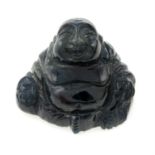 A dark bluish green carved Buddha sapphire, weight 49.30cts.