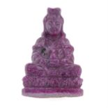 A carved Quan Yin ruby, weight 57.17cts.