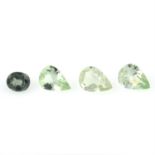 A small selection of pear and oval-shape green gemstones, including sapphire and garnets,