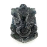 A dark blue-green carved Ganesh sapphire, weight 67.42cts.