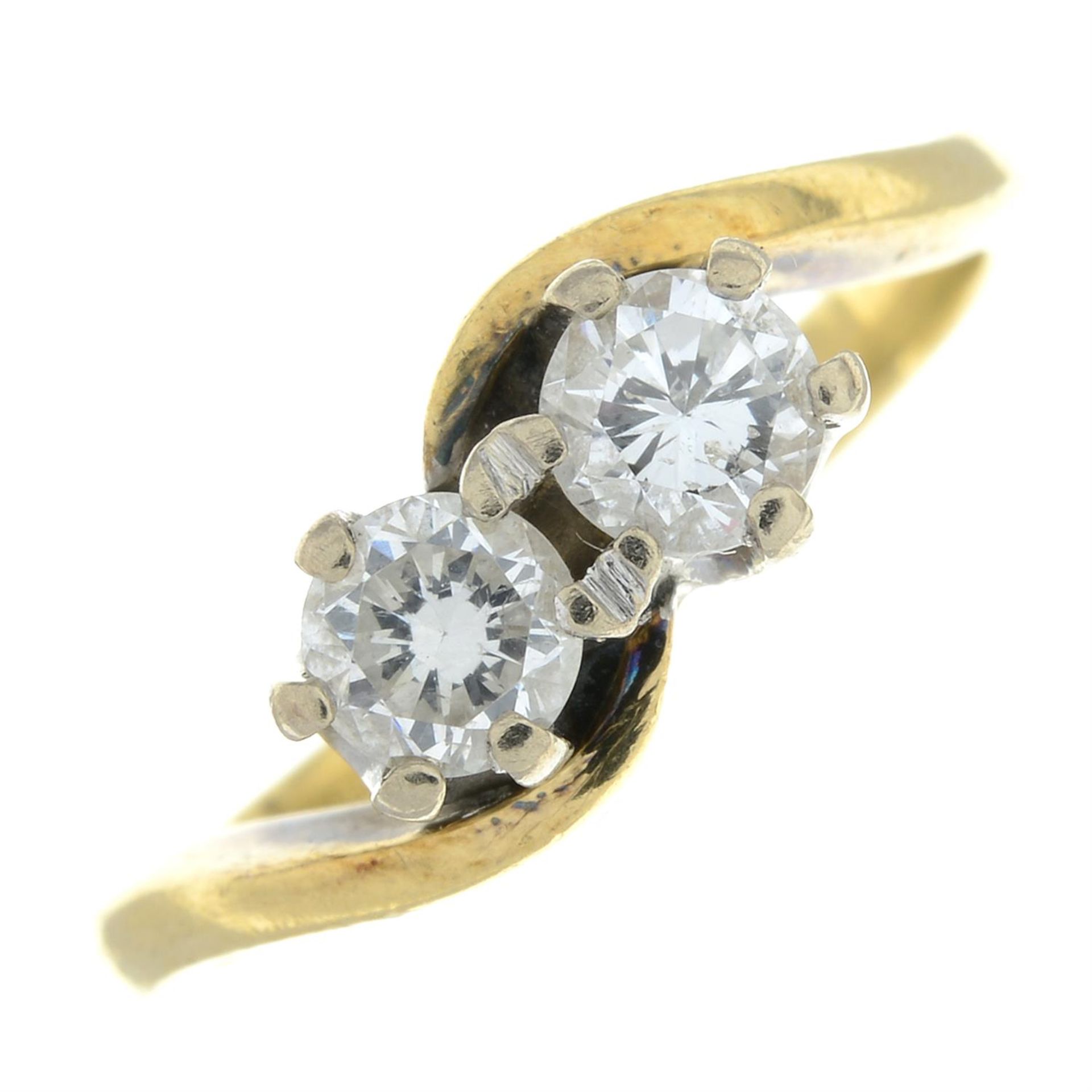 An 18ct gold brilliant-cut diamond two-stone crossover ring.