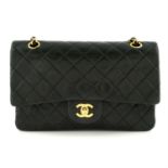CHANEL - a black lambskin leather Classic Double Flap handbag.