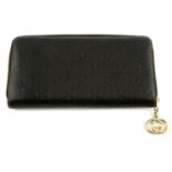 GUCCI - a dark brown Guccissima leather zip wallet.