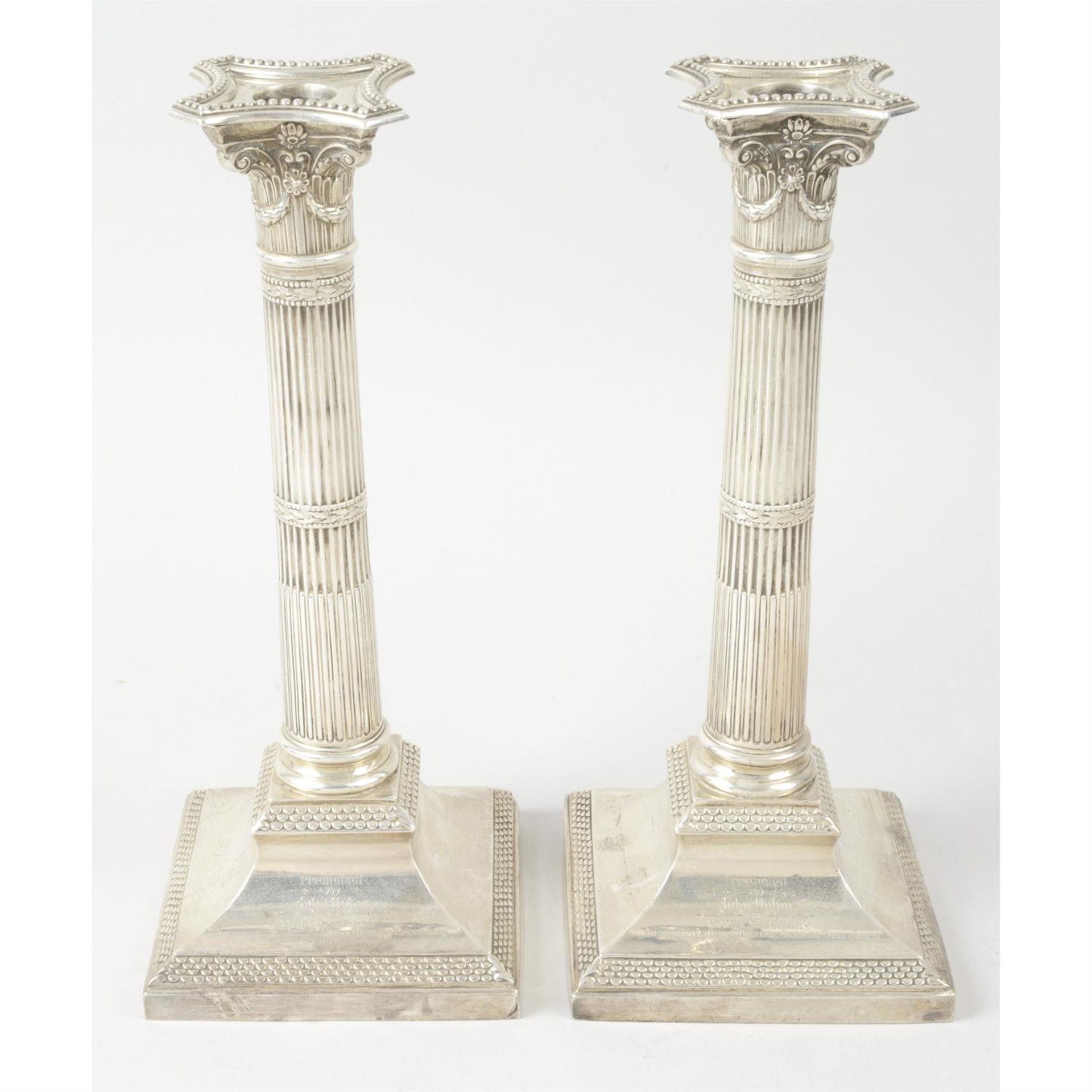 A pair of late Victorian silver mounted classical column candlesticks (loaded).