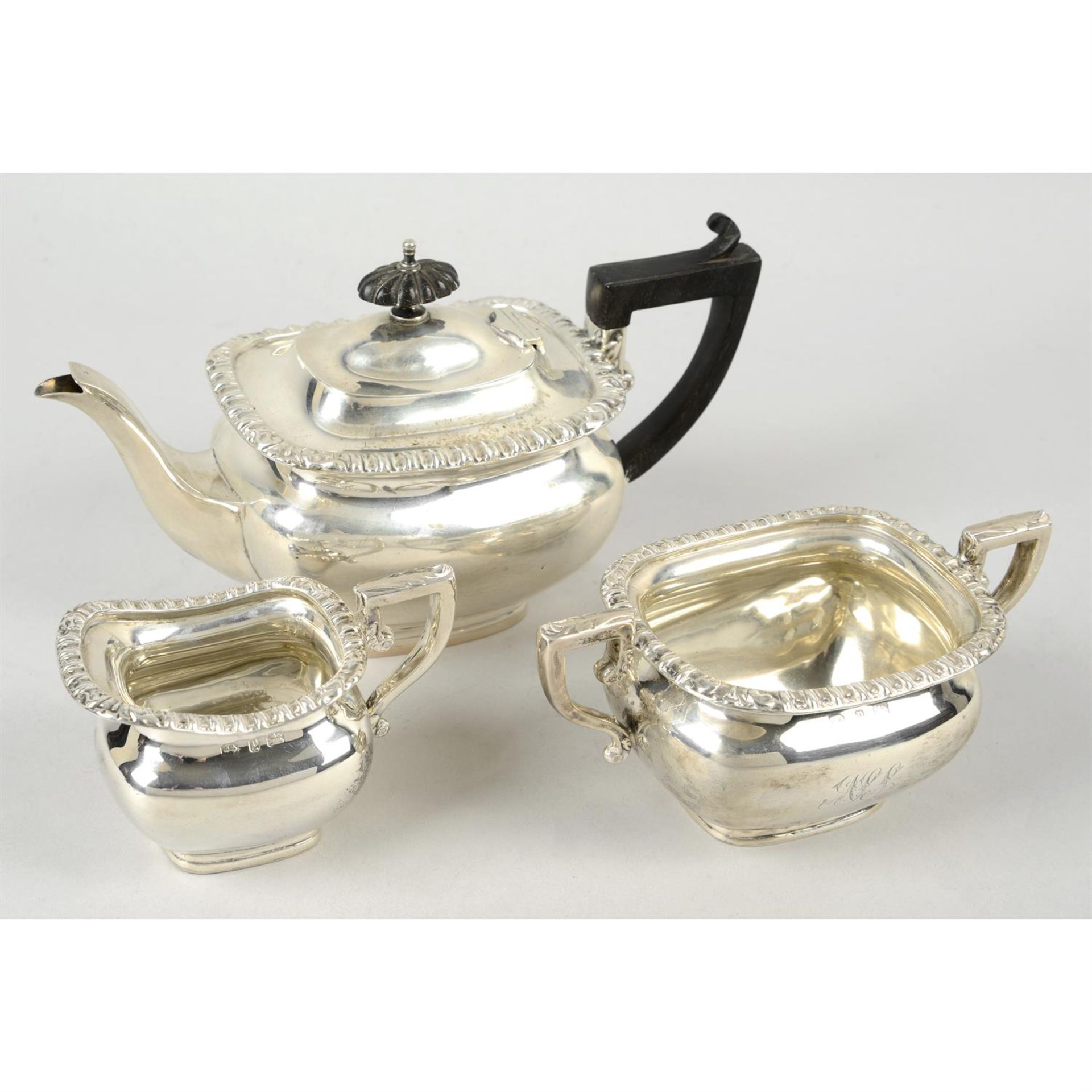 A late Victorian silver three piece bachelor tea set, in fitted case.