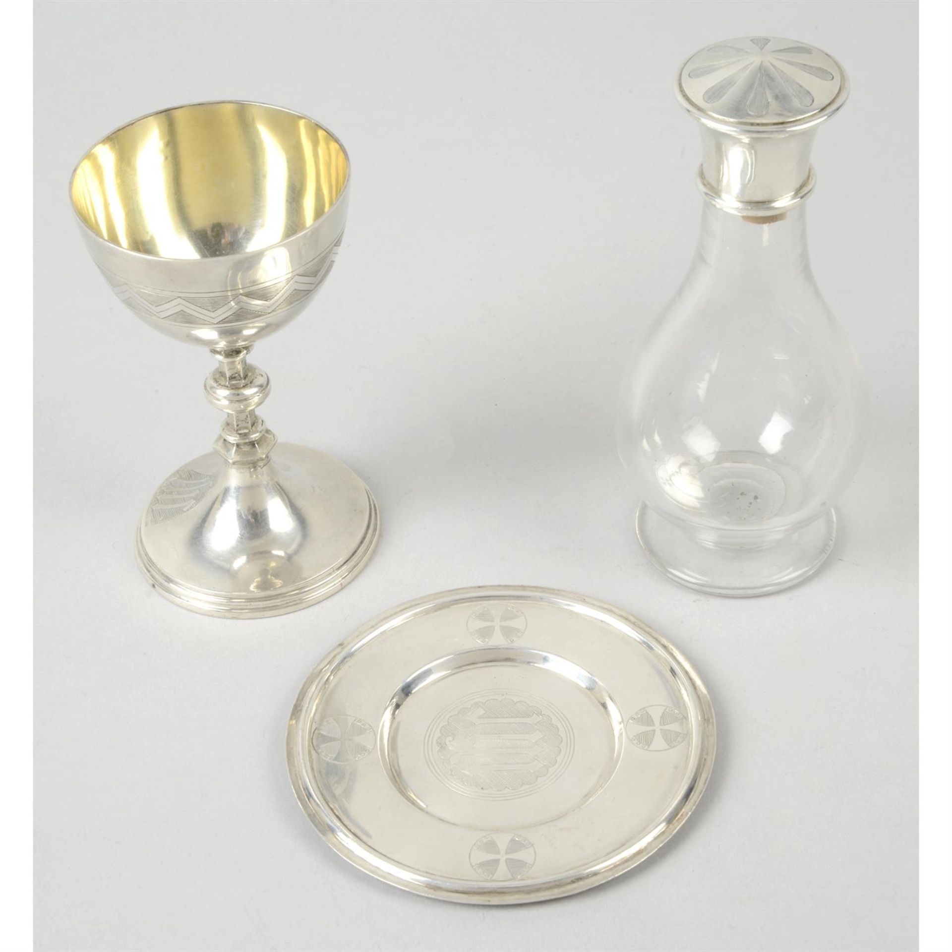 A Victorian silver communion set comprising chalice, paten & glass bottle. (3).