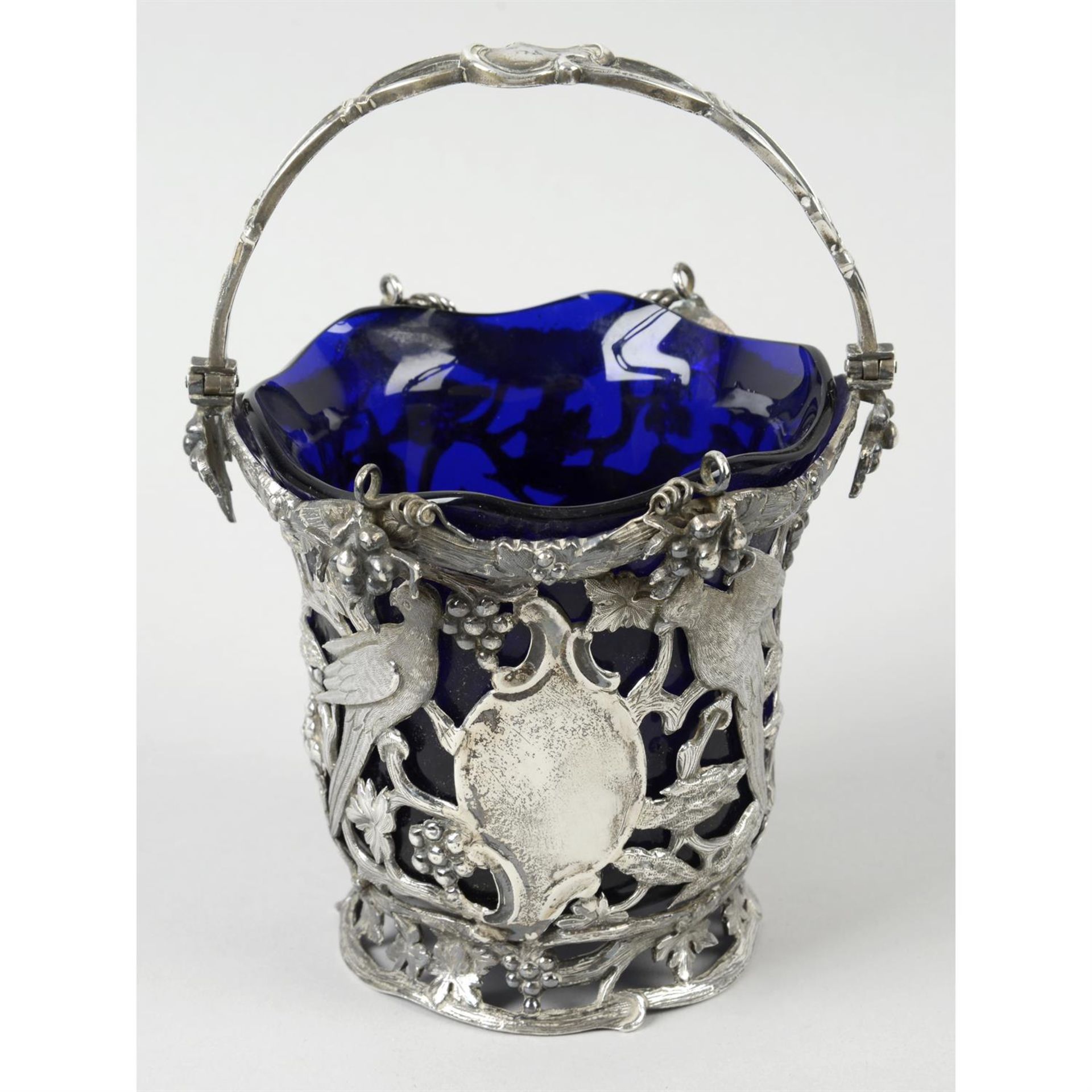 A mid-Victorian silver pierced swing-handled basket with glass liner.
