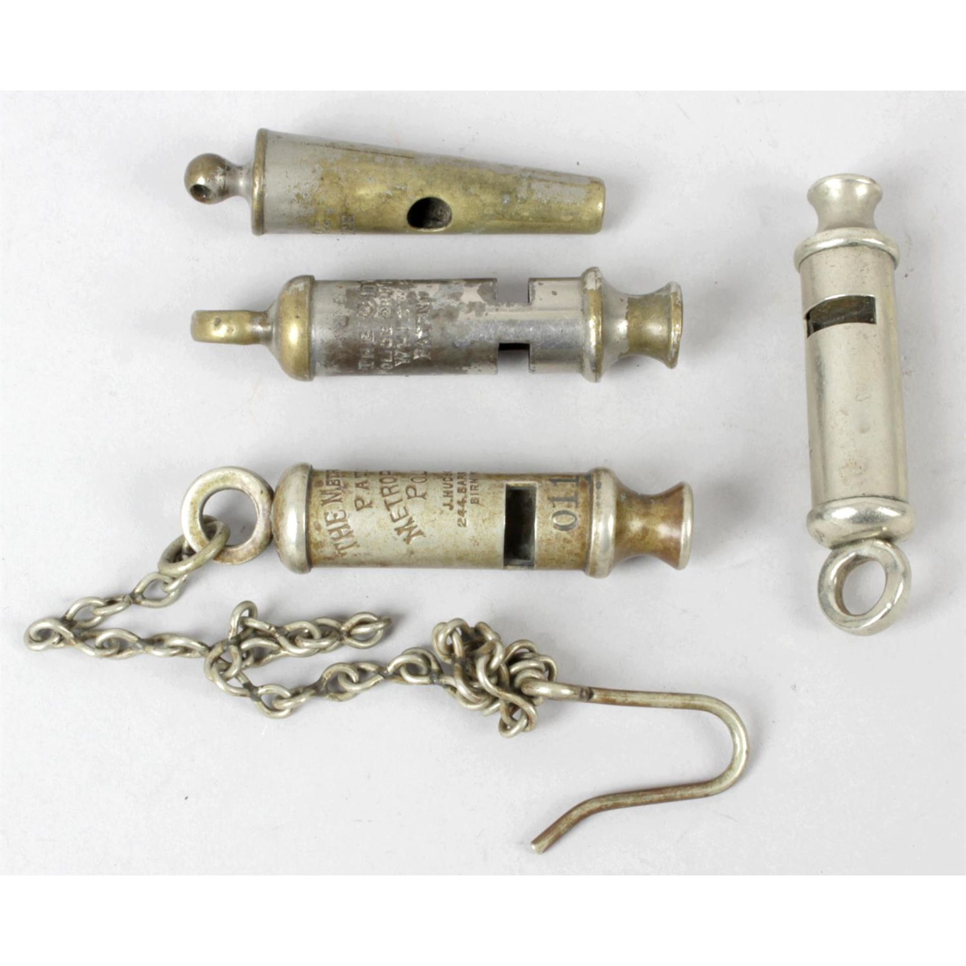 A J. Hudson & Co. trench style whistle, together with three further police/fire whistles. (4)