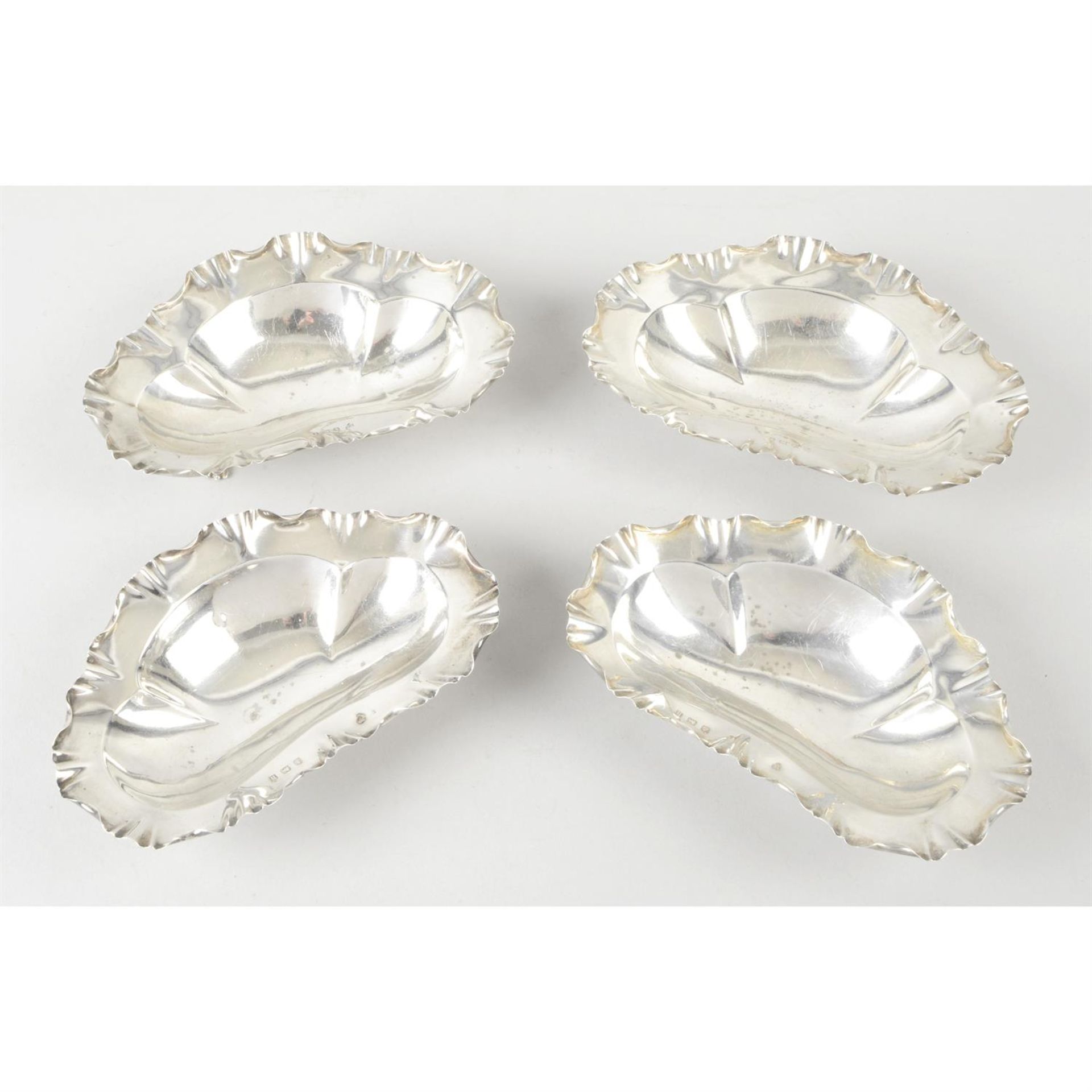 A set of four Edwardian silver dishes.