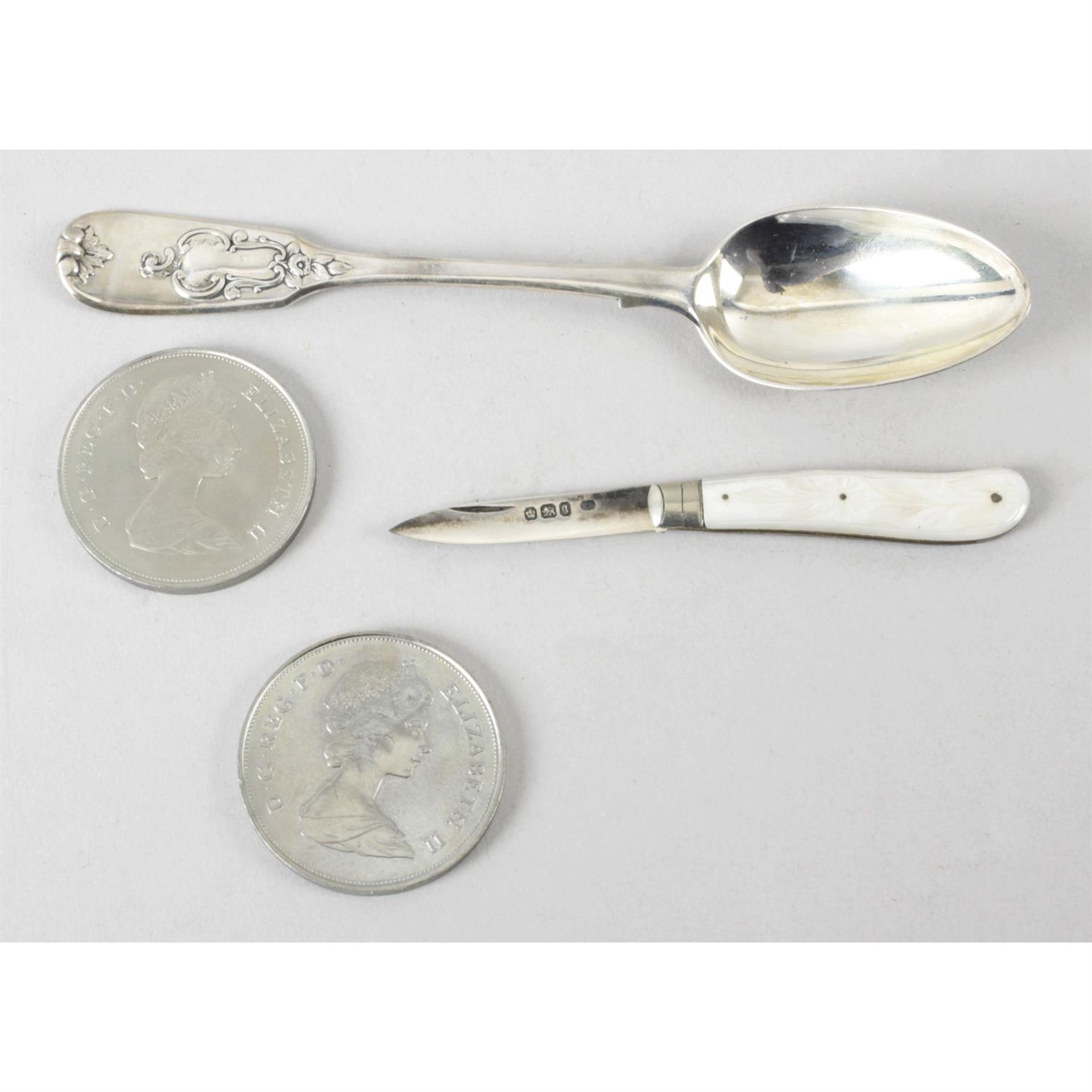 A small silver hallmarked fruit knife and silver spoon, with two commemorative crowns.