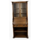 An early 20th century oak arts and crafts style bureau bookcase.