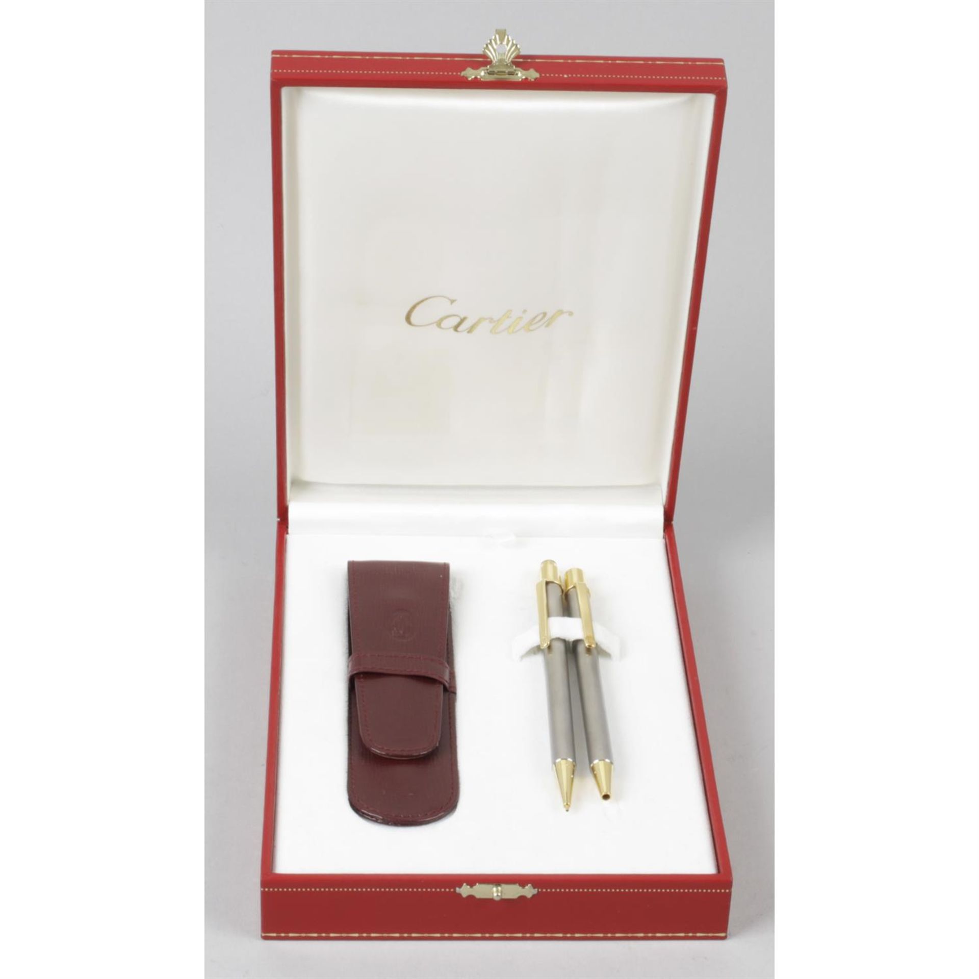 A Cartier 'Twist Action' propelling ball point pen, together with a matching propelling pencil and