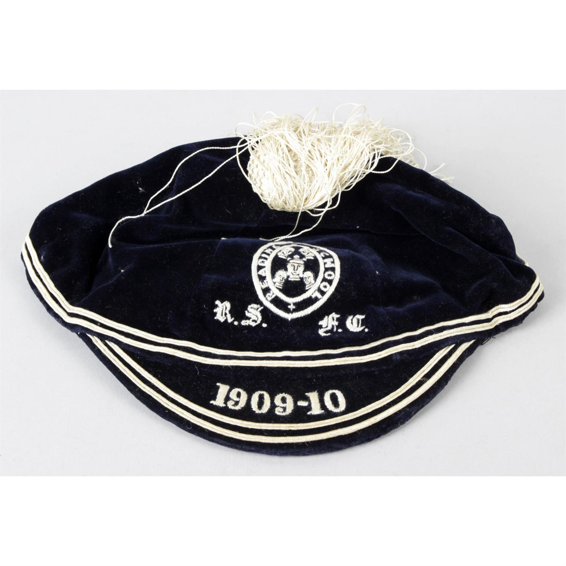 A 1909-1910 Reading School blue velvet cloth cap.