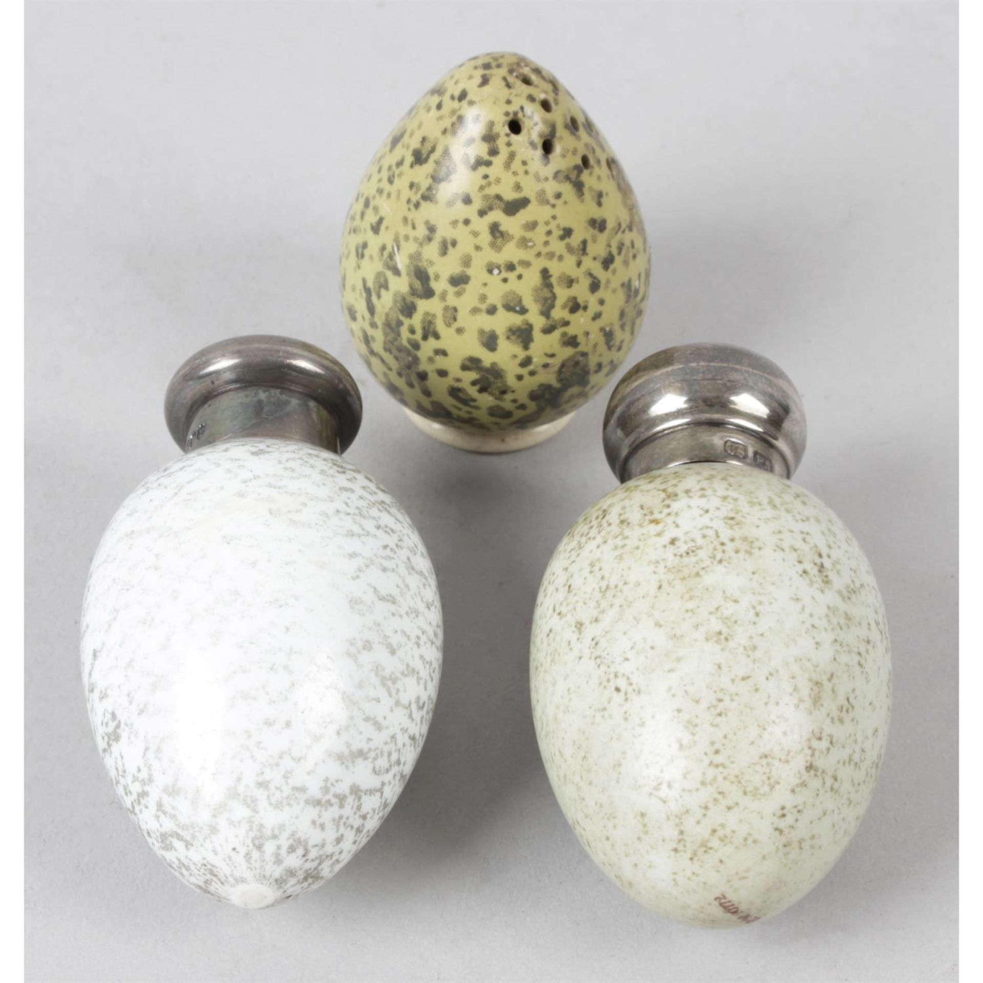 A Victorian novelty 'egg' scent bottle, together with a similar scent bottle and pepper pot.