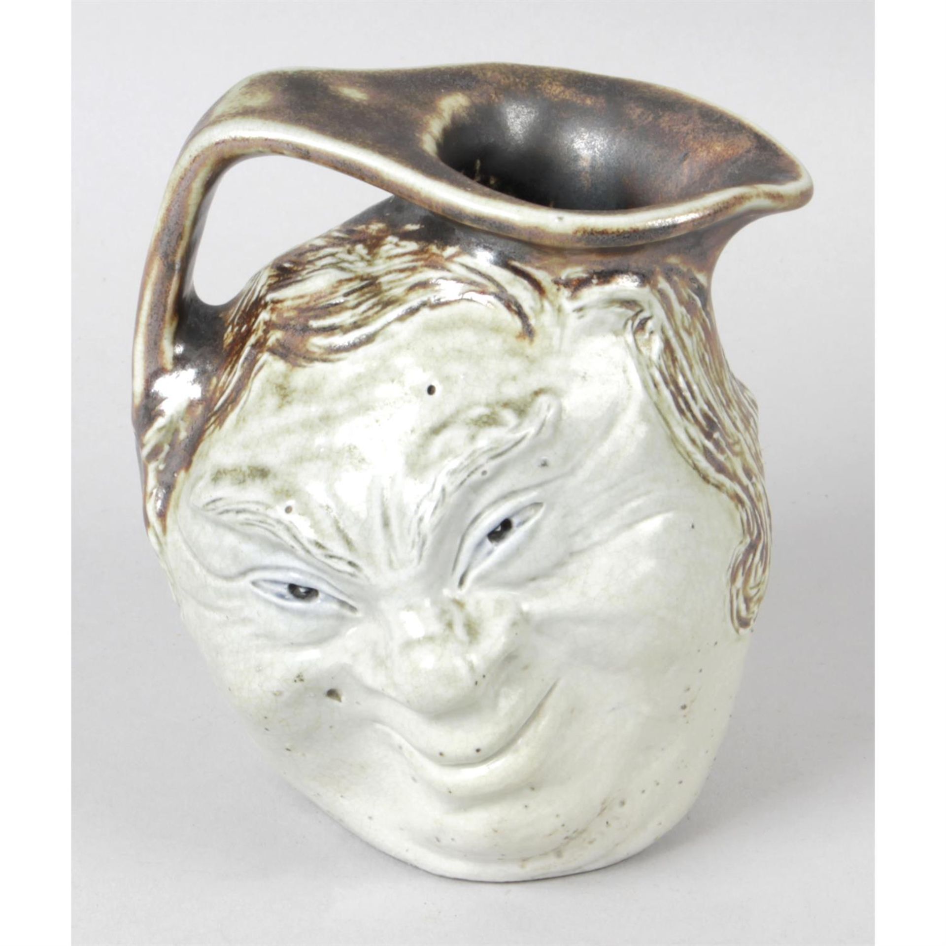 A Martin Brothers pottery 'face mask' jug.