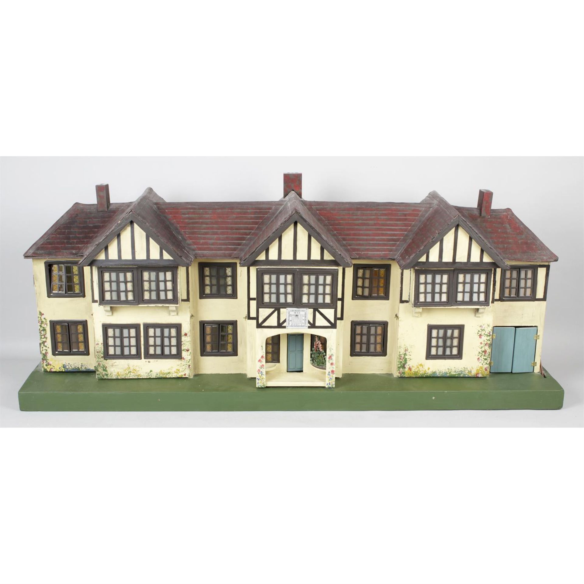 A mid 20th century Triang wooden dolls house, a1930's Triang example and an early 20th century