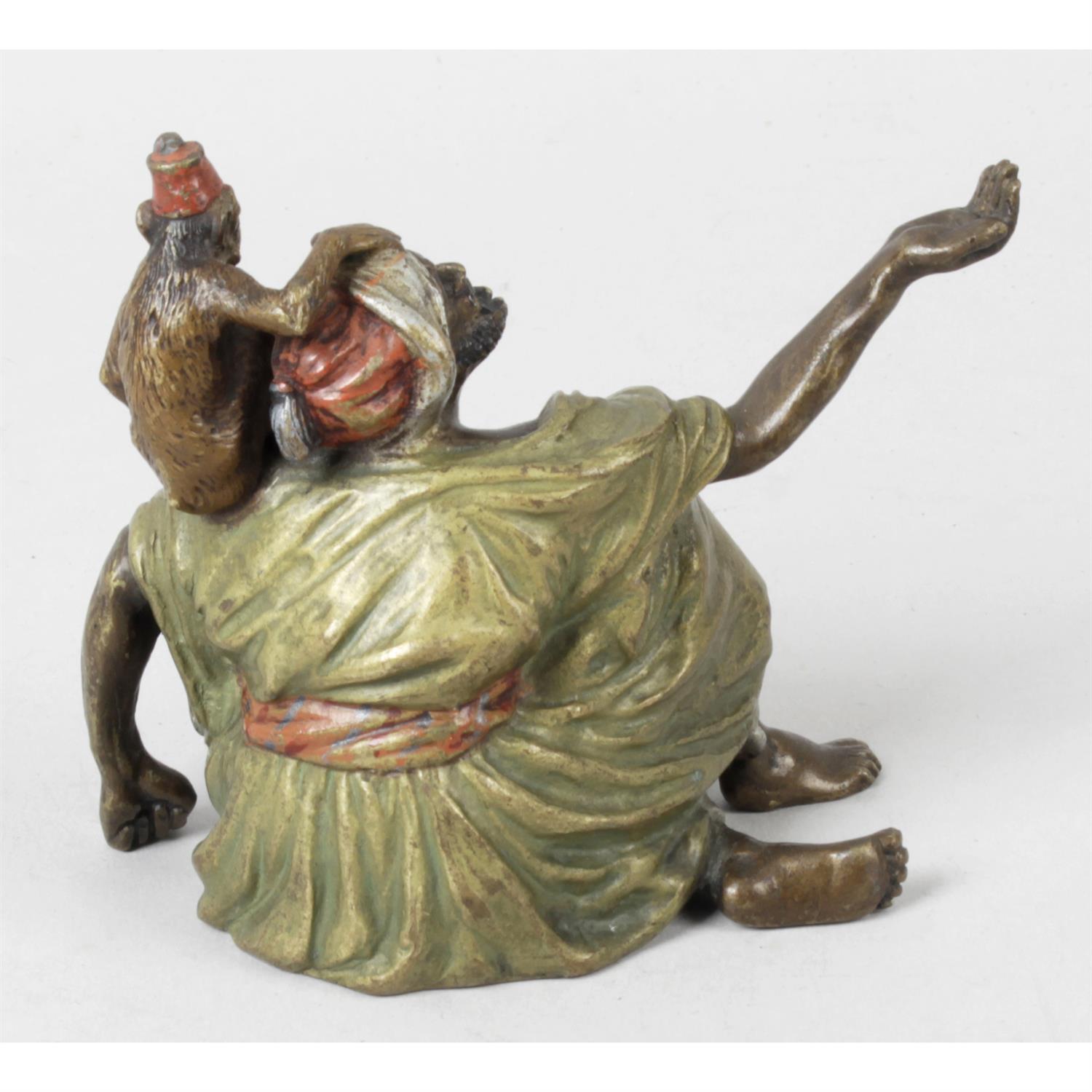 A cold painted bronze figured modelled as a seated male. - Image 2 of 2