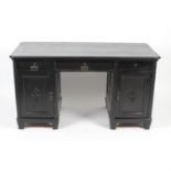 An early 20th century black painted oak bookcase, together with matching desk.
