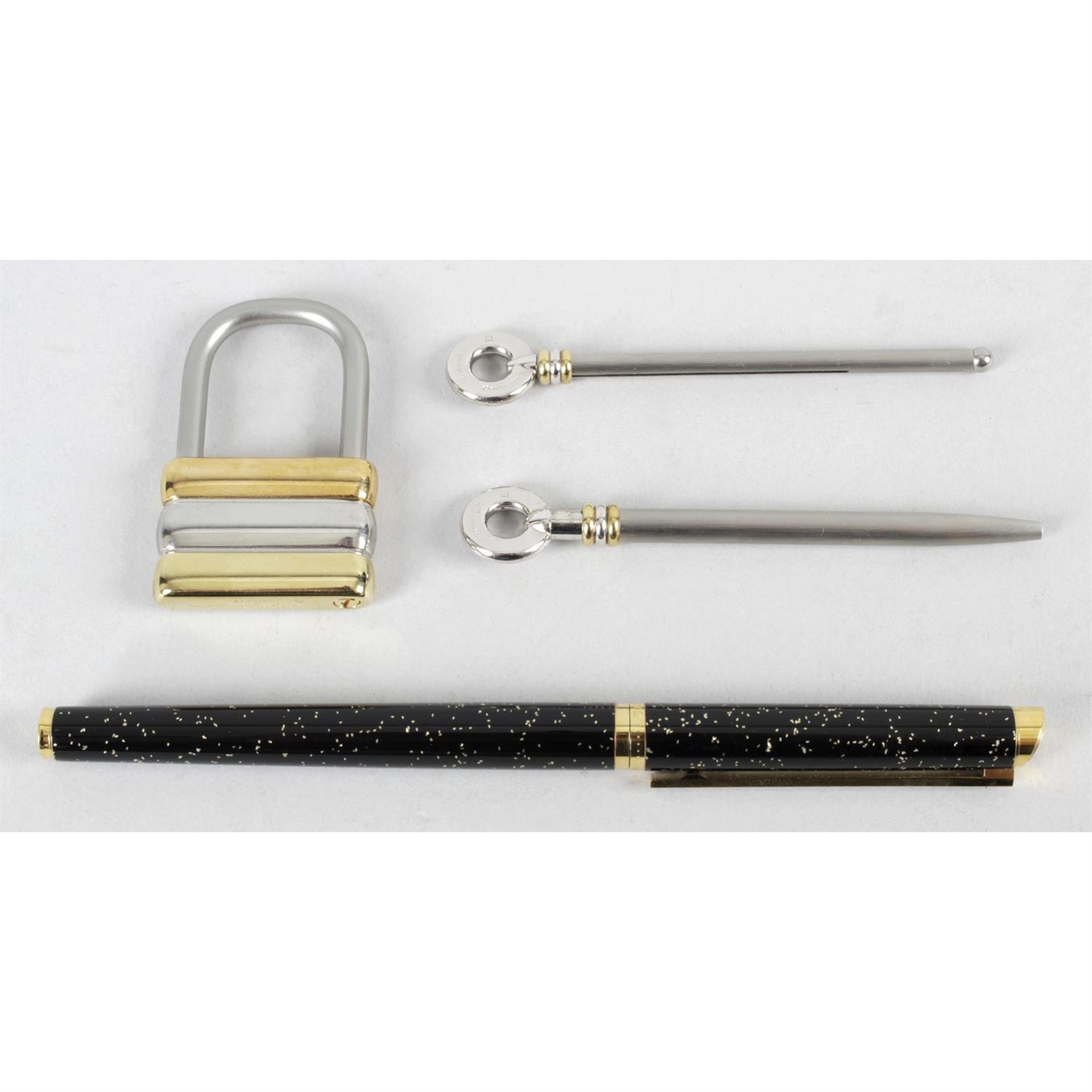 A Must De Cartier padlock keyring, mini ball point pen and champagne swizzle stick,