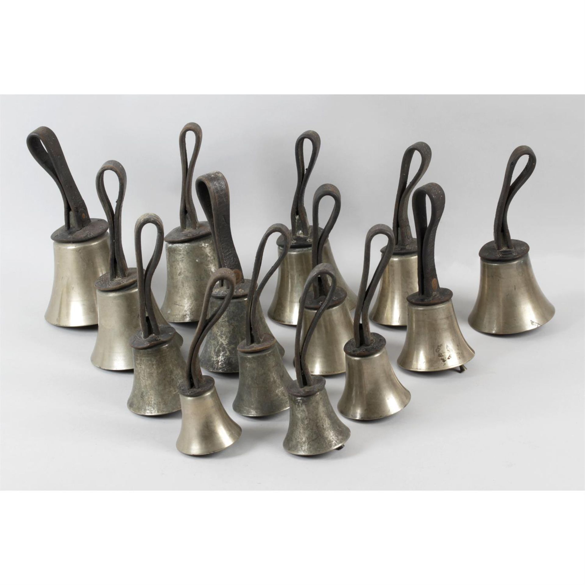 A collection of fourteen Victorian campanology hand bells by J. Shaw and Co. Bradford.